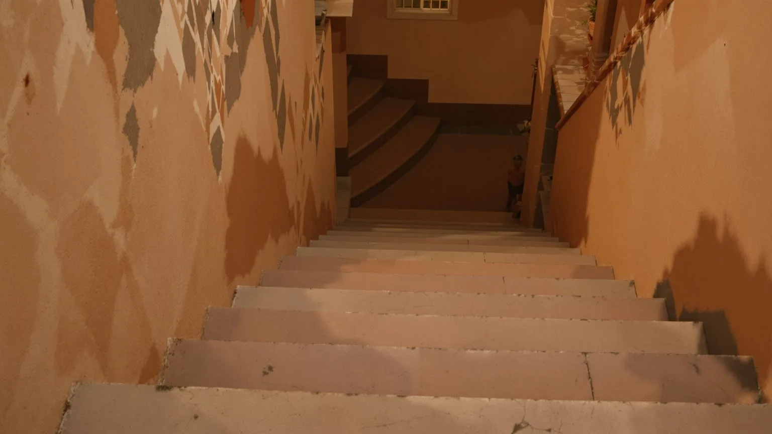 Bare feet paused at the top of stone steps in warm light, body-first shadow work practice