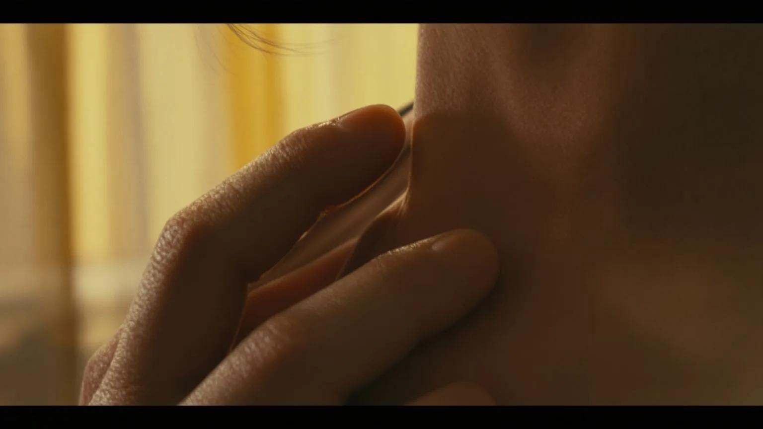 Woman's hand resting on her collarbone showing body tension, shadow work in the body