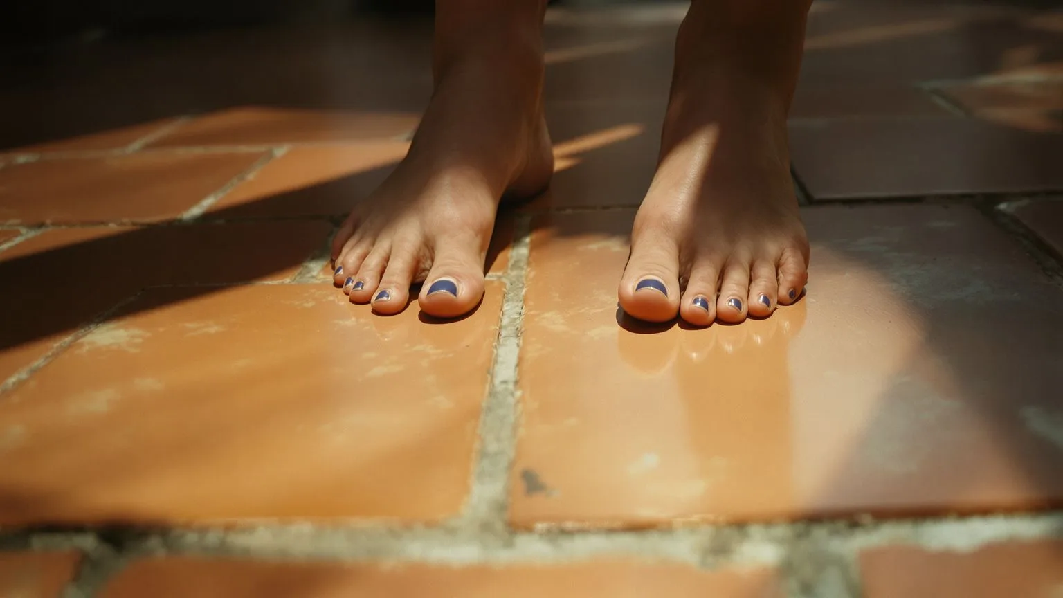 Bare feet gripping terracotta floor in morning light, body-grounded practice for when thoughts won't stop