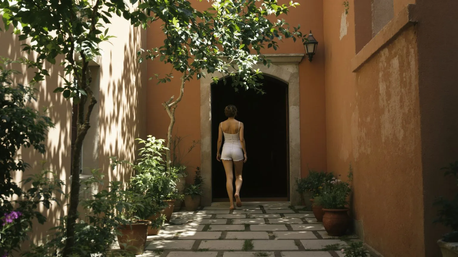 Woman stepping barefoot into a sunlit courtyard from a dim doorway, body opening as related spiritual bypassing traps release