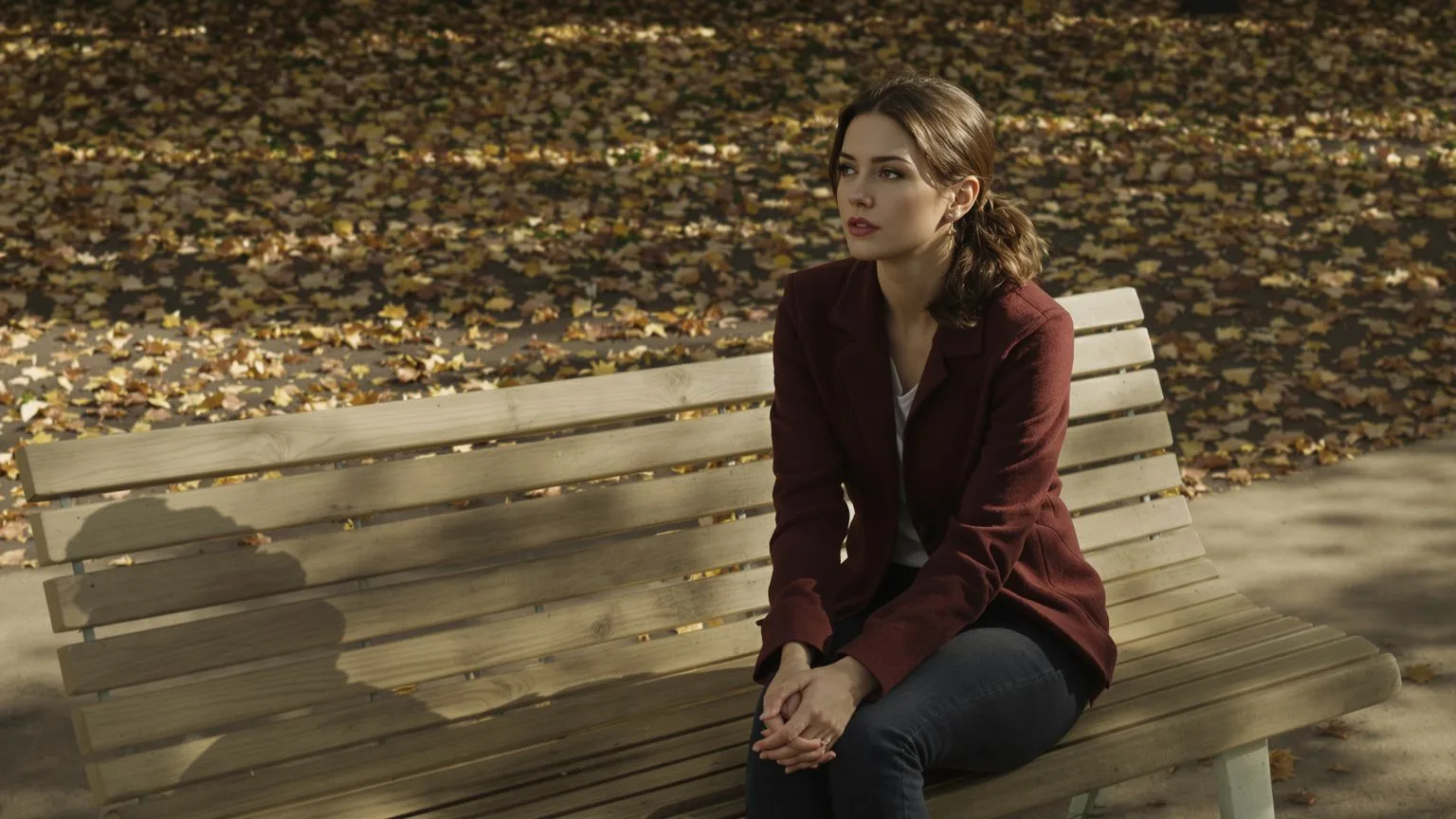 Woman sitting on a bench with tense clasped hands and tight jaw showing people pleasing as kindness Woman sitting on a bench with tense clasped hands and tight jaw showing people pleasing as kindness outside erasure inside