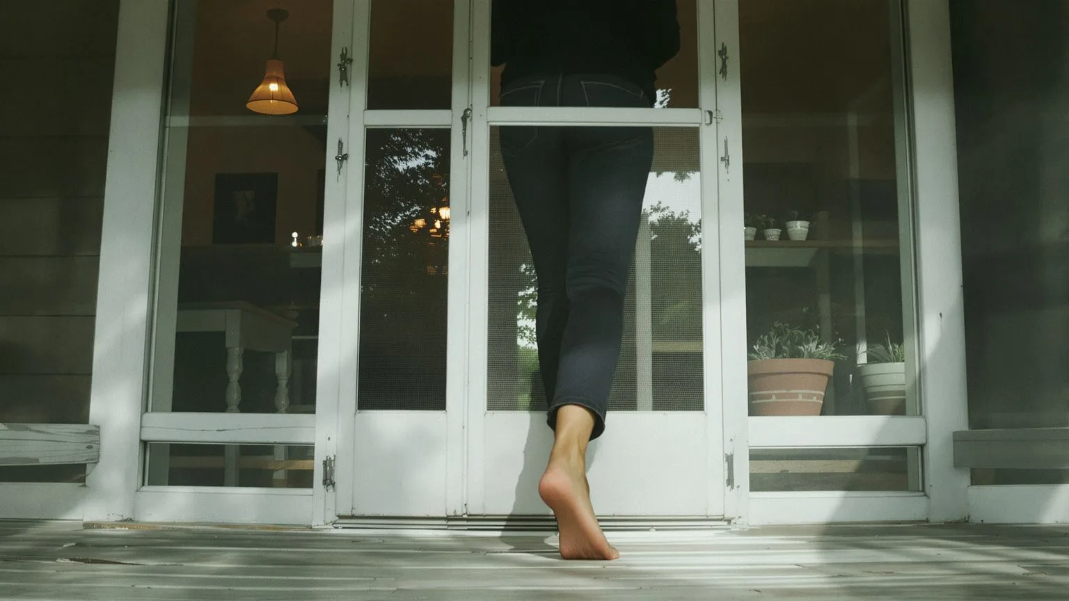 Person stepping barefoot onto sunlit porch as a first step before leaving this page