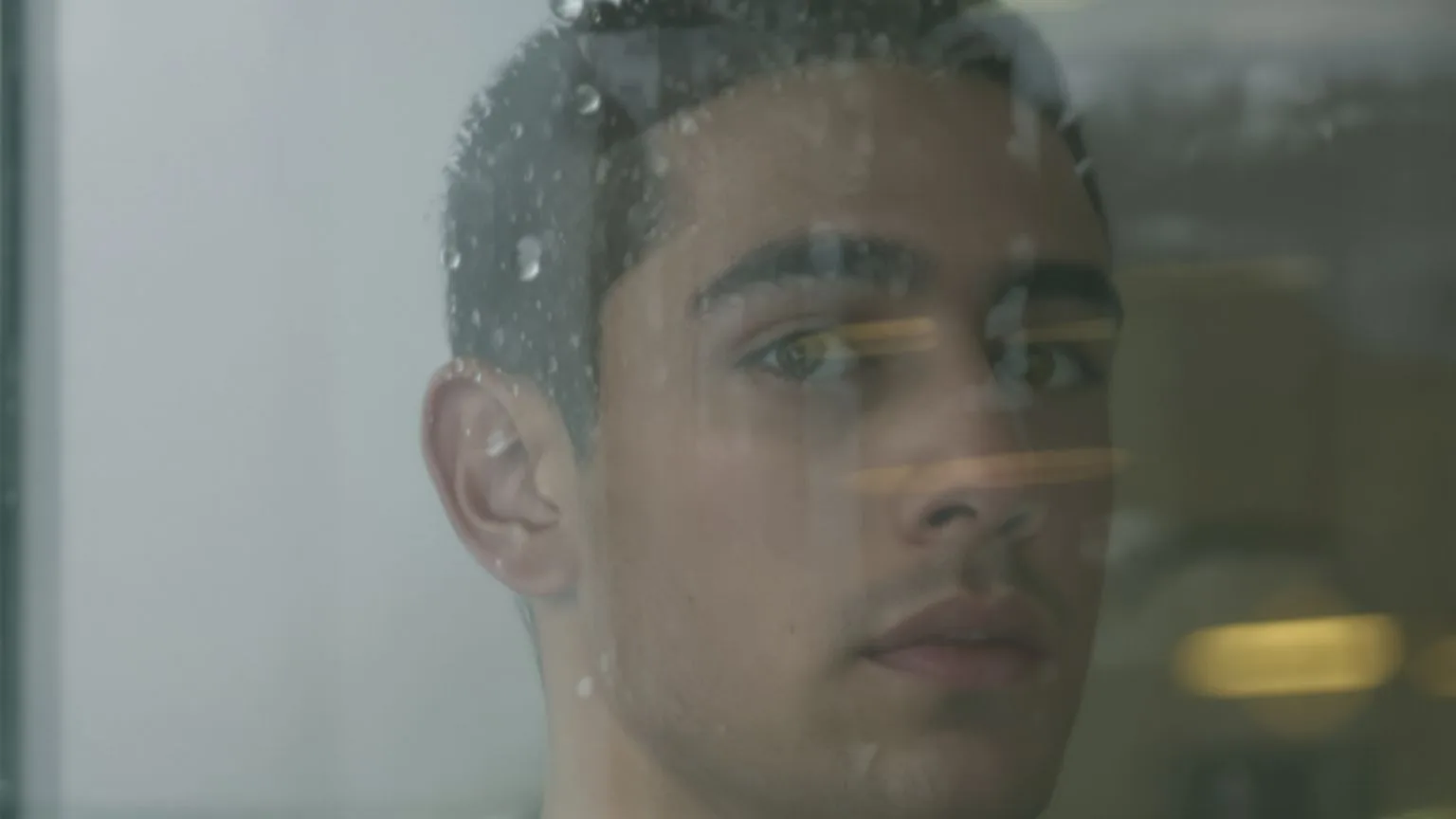 Man's eyes reflected in rain-spotted window capturing why being truly seen feels relieving and scary Man's eyes reflected in rain-spotted window capturing why being truly seen feels relieving and scary