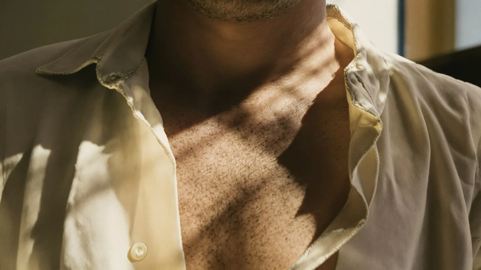 Close-up of chest and breath softening after practicing being real showing [physical](/10-physical-symptoms-of-spiritual-awakening/) relief in warm light