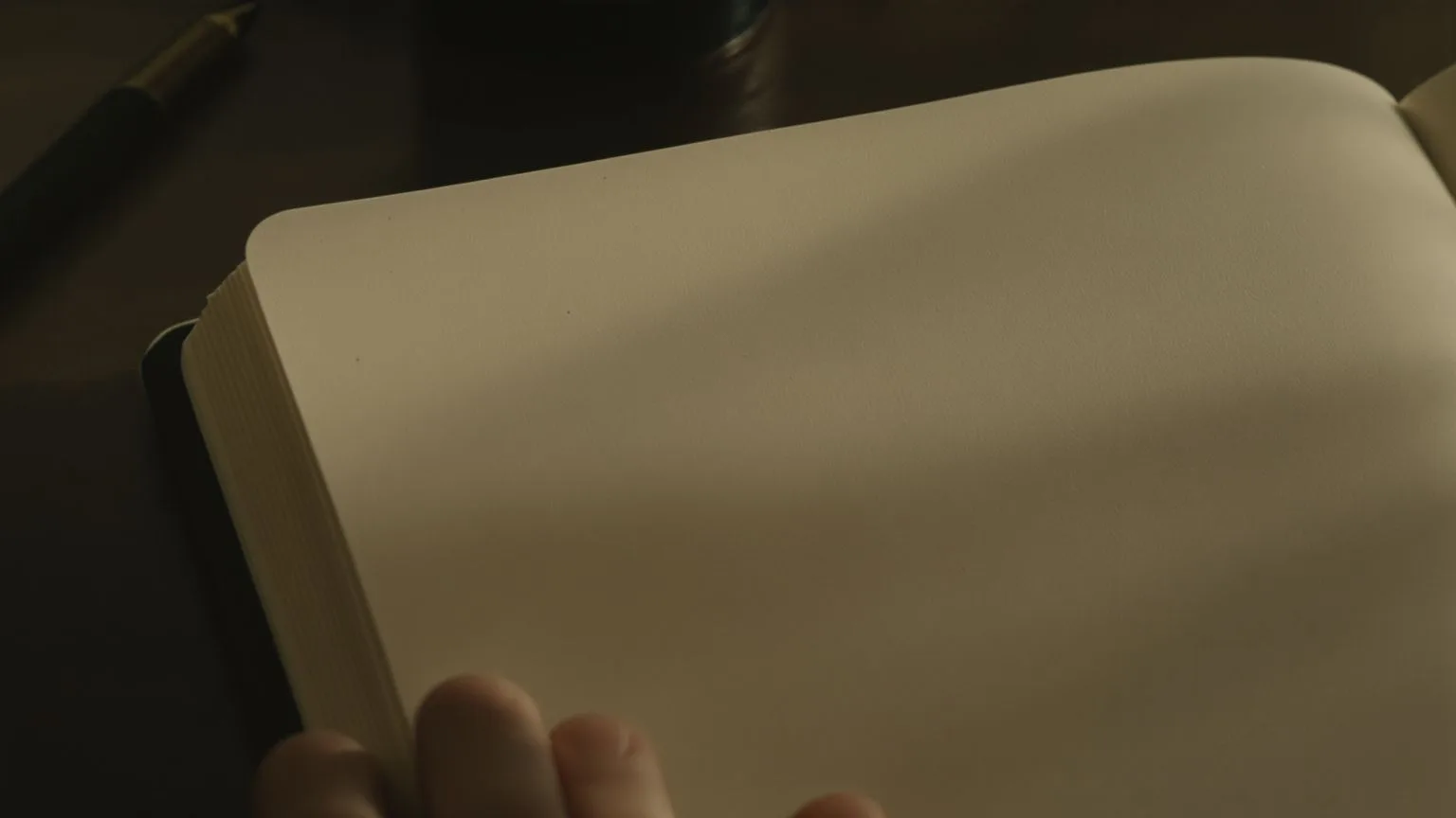 Fingertips resting gently on open journal page with pen laid down, the real question beneath feeling Fingertips resting gently on open journal page with pen laid down, the real question beneath feeling misunderstood