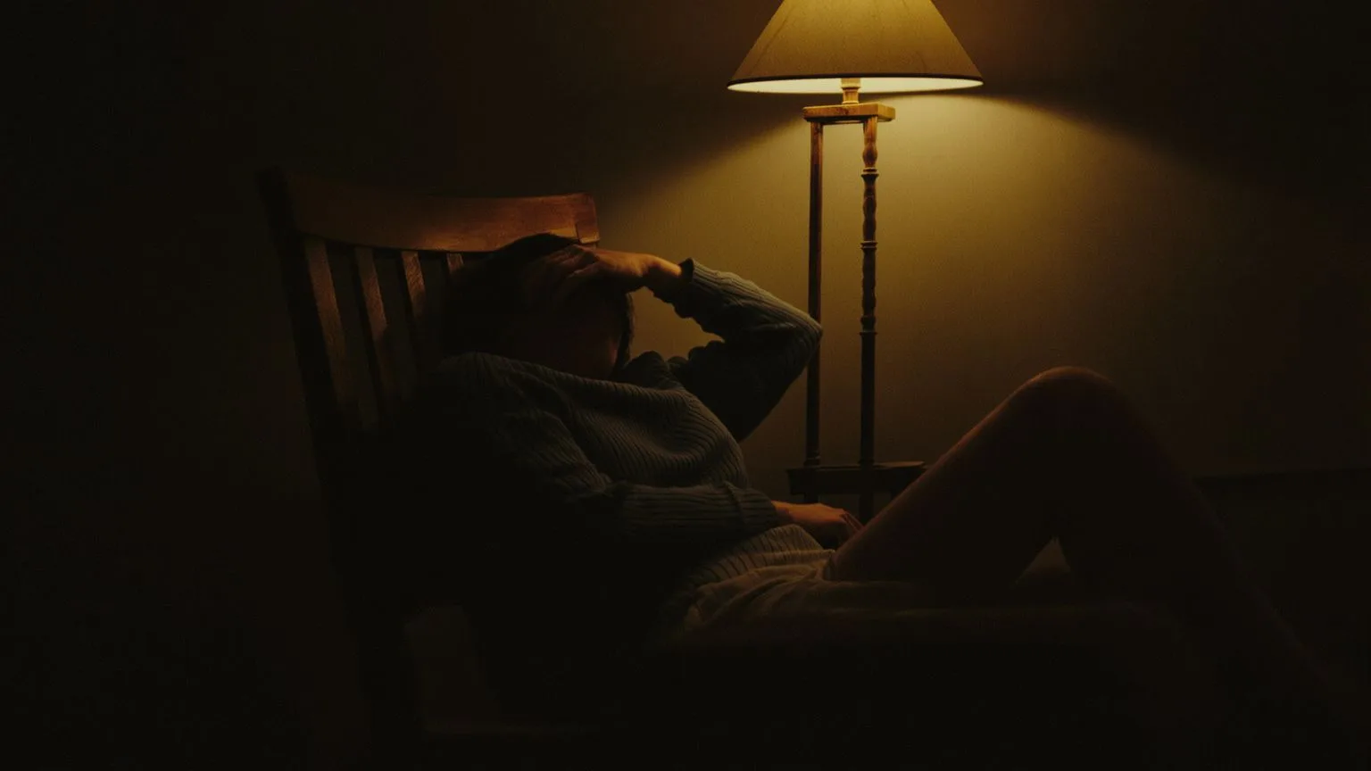 Person in contemplative pose recognizing complexity of ego versus intuition after personal growth work