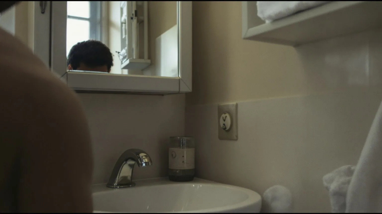 Man gripping bathroom sink edge with blurred mirror reflection showing why the emotional shutdown cy Man gripping bathroom sink edge with blurred mirror reflection showing why the emotional shutdown cycle repeats