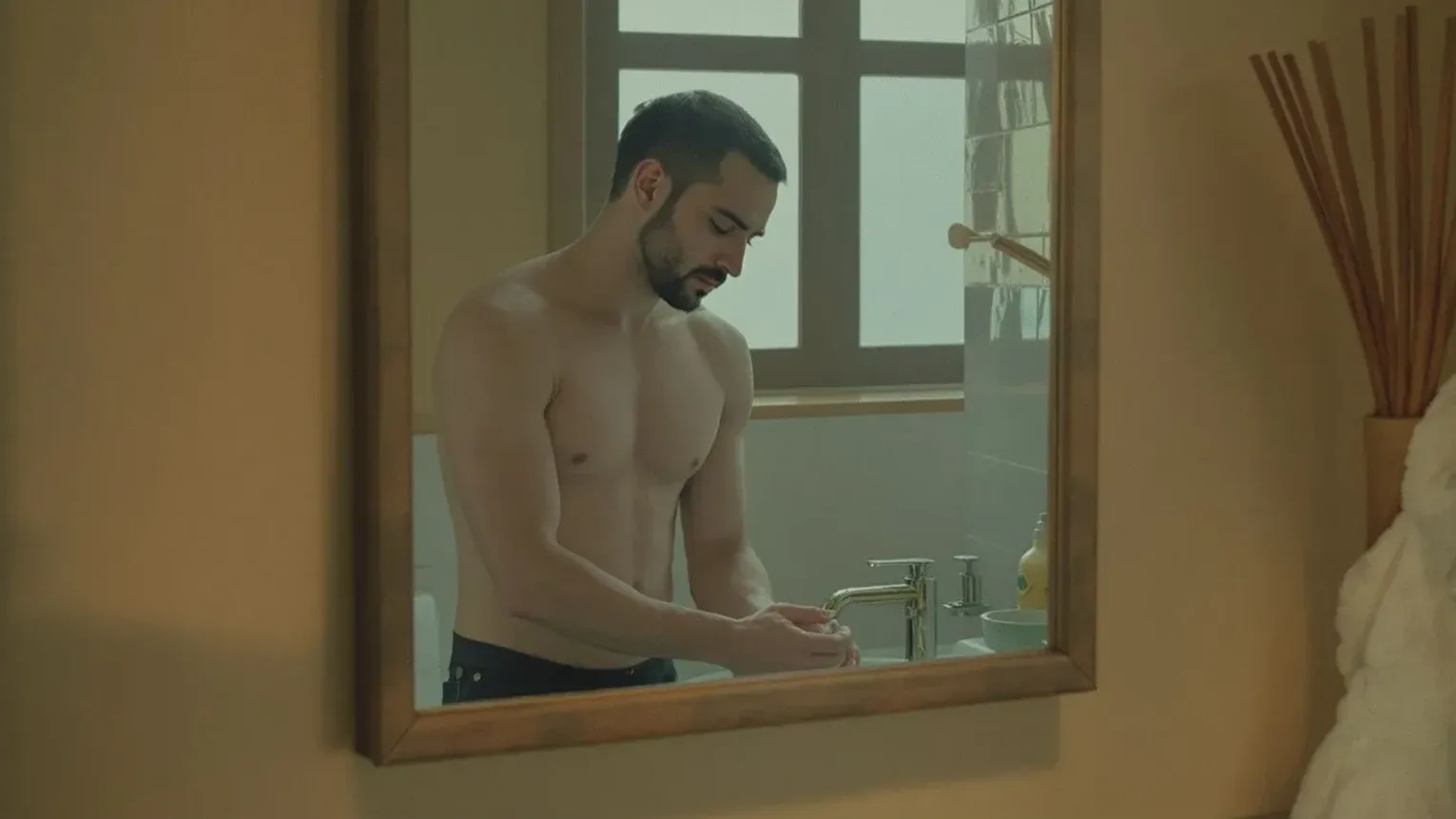 Man at bathroom sink looking down at running water in mirror reflecting the pressure you can feel but can't release