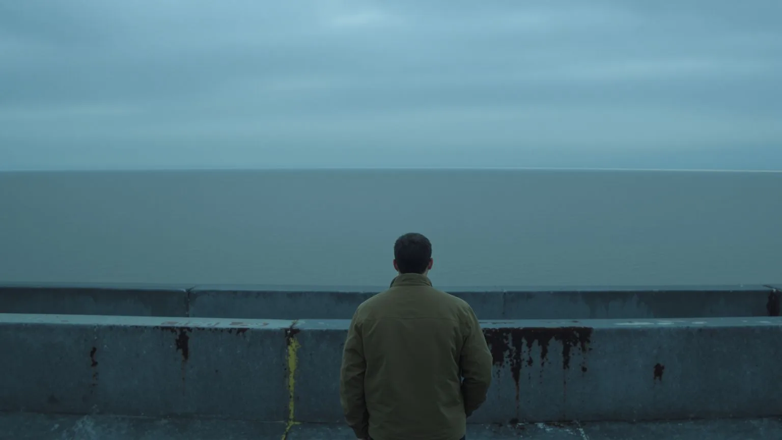 Hands resting beside empty ceramic bowl on wooden table in soft light, why you feel so empty