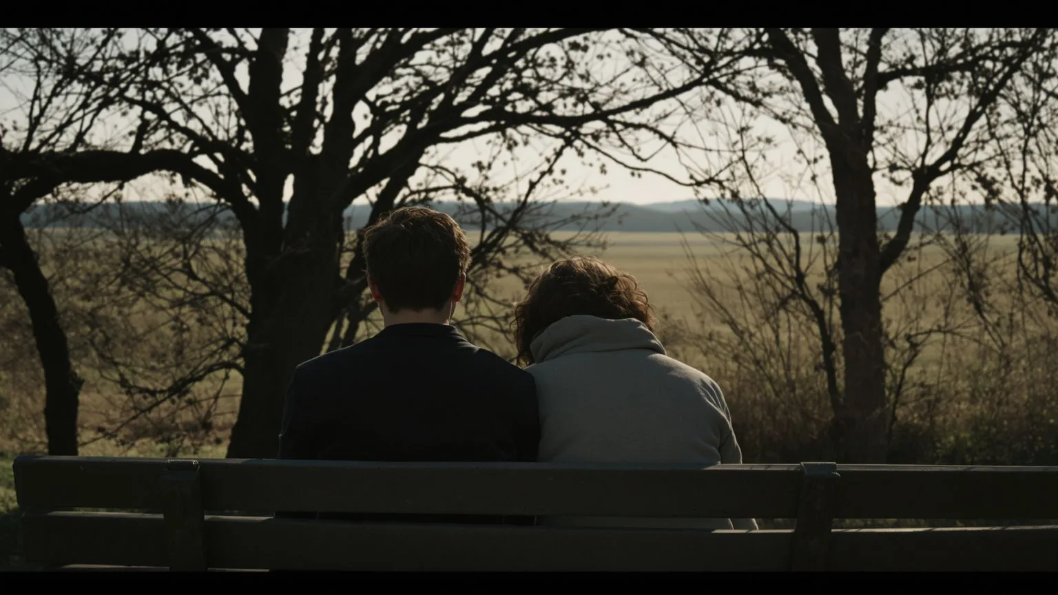 Two people sitting peacefully on bench, demonstrating healthy boundaries in close relationships Two people sitting peacefully on bench, demonstrating healthy boundaries in close relationships