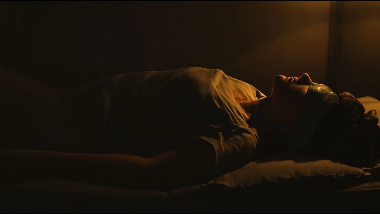 Woman resting on grounded mat with T-shirt over eyes and palms down, moving through Feeling Session Woman resting on grounded mat with T-shirt over eyes and palms down, moving through Feeling Session phases of self-love practice